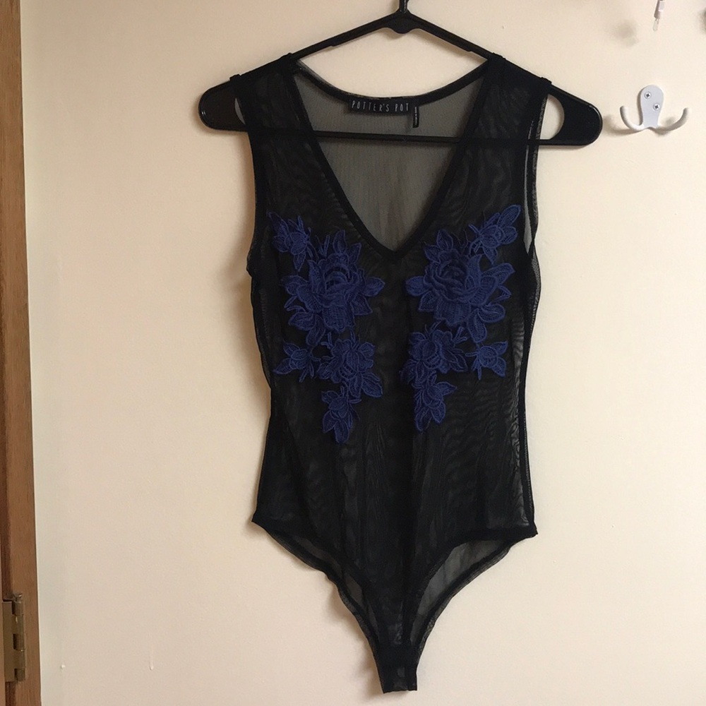Sheer black onesie with blue flowers.